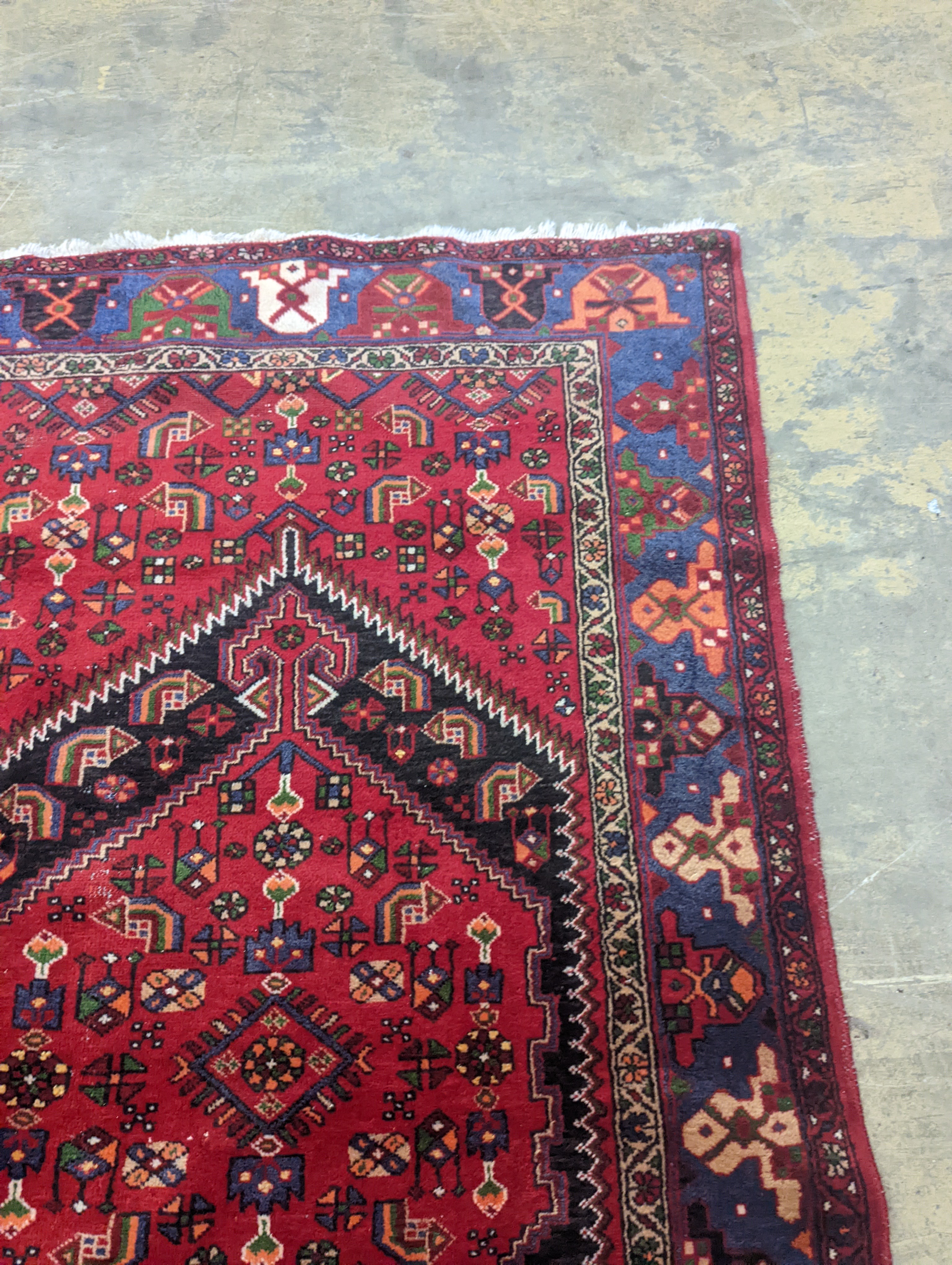 A Hamadan red ground rug, 220 x 130cm